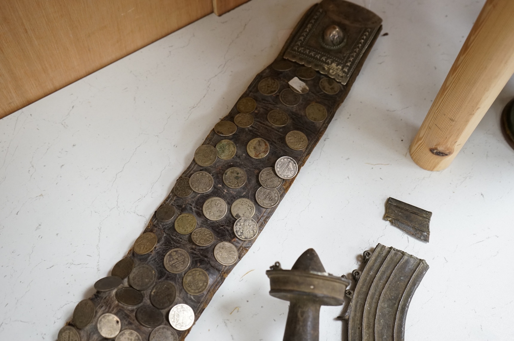 A 19th century Persian silver, niello work and coin mounted belt, dated 1880 (1297 AH in script) and an African sword (broken)